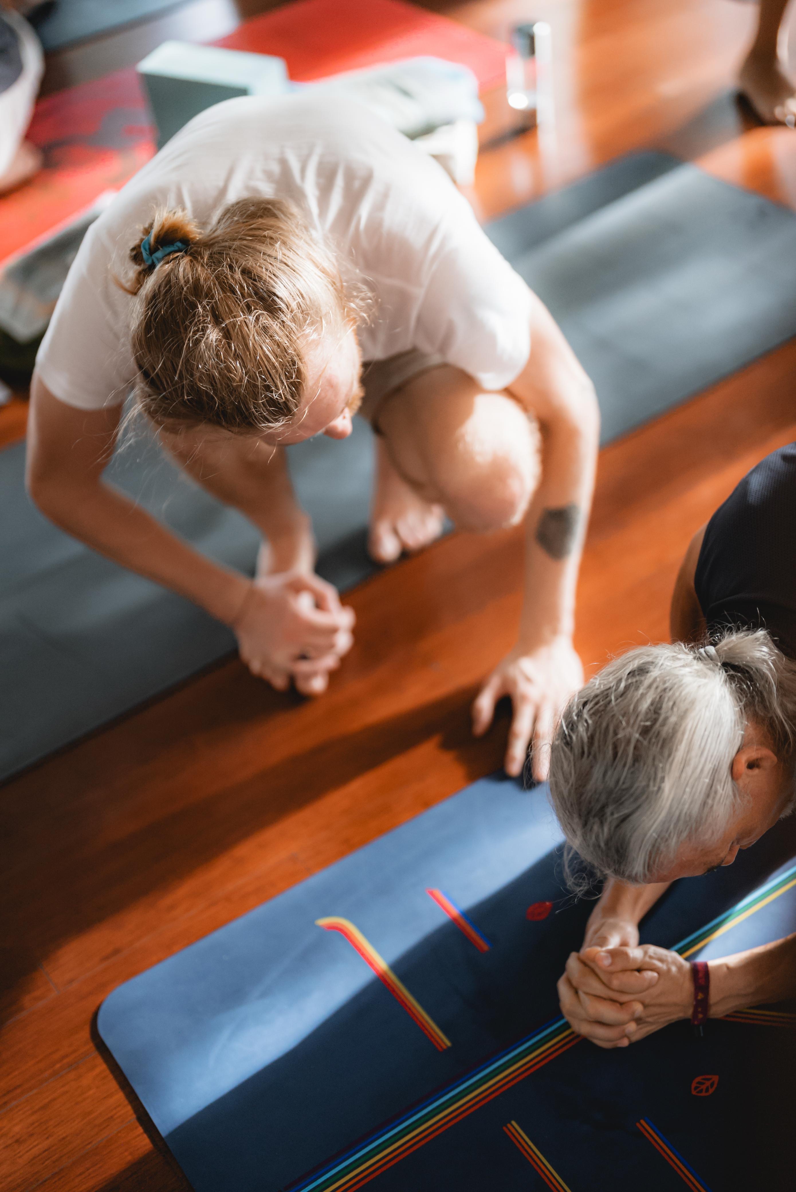 Solomon guiding student through yoga practice